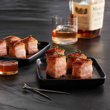 crispy pork belly bites with smoked paprika and honey whiskey drizzle