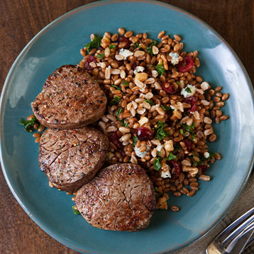beef tenderloin medallions with wheat berry, kale and cranberry salad